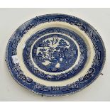 A 19th Century blue and white Willow Pattern charger, transfer printed,