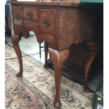 An 18th century and later walnut three drawer lowboy with later elements,