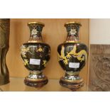 Pair of Chinese Cloisonné baluster vases, mounted on carved Chinese stands,