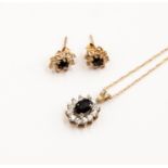 A sapphire and CZ pendant set in 9ct gold with fine chain, along with and two matching earrings,