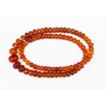 A reconstituted amber necklace, graduated faceted beads,