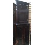 Two oak corner cupboards with brass hinges,