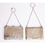 An Edwardian silver card/aide memoire case with finger chain, damaged, chased with foliate scrolls,