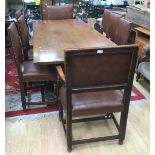 An oak refectory table with eight leather upholstered chairs.