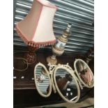 Two lamps with shades and a wall mounted mirror