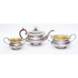 A George III three piece silver tea set, by Joeph Angell I, London 1814-16, comprising teapot,