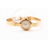 A circa 1960's ladies Garrard 9ct gold bracelet watch, mechanical movement, small white metal dial,