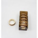 A set of six James Macintyre napkin rings, circa 1890's, brown marbled glaze with gilt bands in