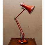 A mid 20thC Anglepoise lamp. Orange painted metal on heavy base. Extends to approx 1 metre.