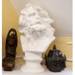 Three decorative statues including male bust, hanging primitive monkey carving, and oriental