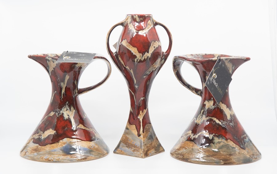 A pair of Black Ryden red - cream handled jugs, together with a two handled vase (3) Largest 27cm