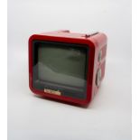 A 1980’s MTV7 Portable black and white television, 7 inch screen, outer case in vivid red colour,