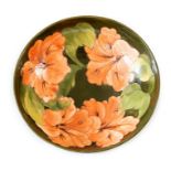 A pre-war Moorcroft bowl decorated with peach coloured flowers and green stems. Moorcroft label,