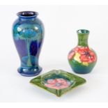 Moorcroft green ashtray, green vase and a blue vase (3) Condition: restoration to the rim of the
