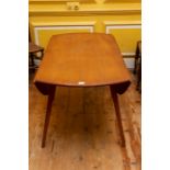 An Ercol light elm and ash dropleaf dining table, circular form on tapered legs, 113cm diameter,