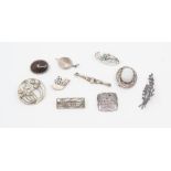 A collection of nine silver brooches, including mother of pearl, hard stone, two in the style of