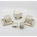 A Foley china Cube teaset (missing one saucer), fruit pattern with white ground, red, blue and