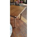 A 1970s rosewood veneered rectangular topped extending dining table, of Danish design, fitted with a