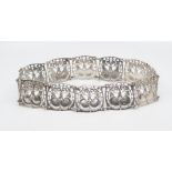 Jessie M King (attributed) for Liberty and Co., an Arts and Crafts silver belt, each of the twelve