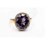 An amethyst and diamond oval cluster ring, the oval amethyst approx 11 mm x 10 mm,