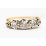 A five diamond diamond dress ring, the central old cut diamond weighing approx 0.