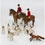 J Beswick huntsman with dogs and fox along with a huntsman on horse back