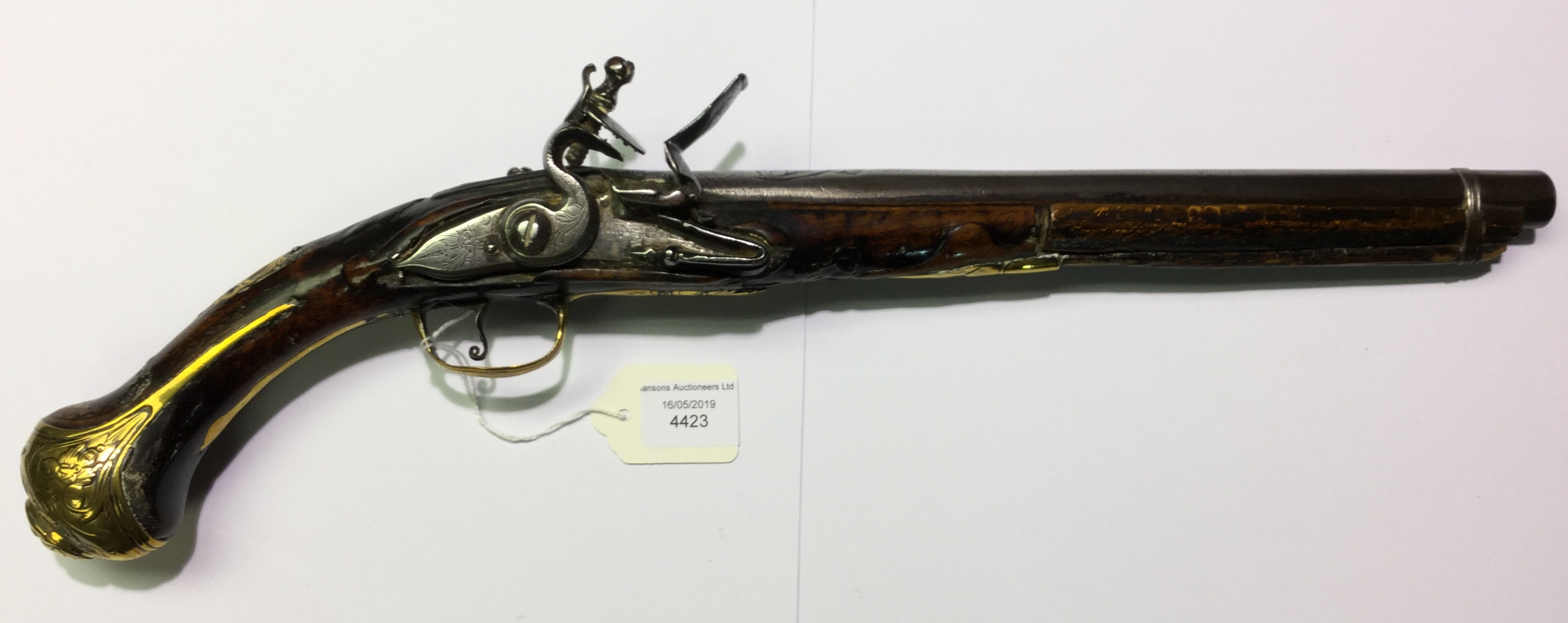 Flintlock pistol with 300mm long barrel. Engraved barrel with grotesque mask.