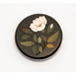 Ashford marble, a circular brooch, inlaid floral spray, white metal mount, approx 4.