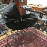An early 20th century carriage pram, possibly Edwardian, full size canoe shaped body, circa 1900,