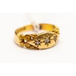 A Victorian diamond set ring, star set with three small diamonds, scroll mount, size J,