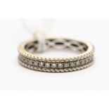 A diamond eternity ring, claw set with round brilliant cut diamonds, in 18 ct white gold, rope edge,