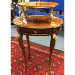A French oval two tiered Ergetere, Kingwood veneered, brass beading to edge,