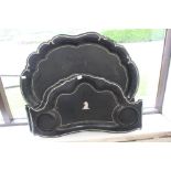 A set of three papier mache trays, a centre tray and two matching trays,