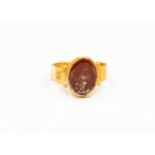 A Roman Empire 2nd/3rd Century AD carnelian intaglio ring, depicting a Roman Deity,