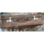 An early 20th Century brown leather travelling suitcase, with original handle,
