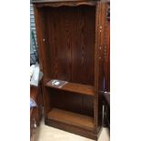 A traditional oak open bookcase, with five shelves,