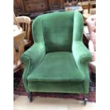 An Edwardian green upholstered armchair