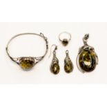 A collection of amber and silver jewellery to include a silver mounted pendant,