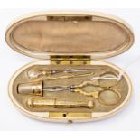 A French late 19th Century Necessaire with an oval ivory case fitted with a French gold needle case,