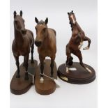 Two Beswick horses on stands and a Royal Doulton horse on stand