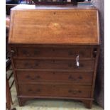 An Edwardian oak and parquetry inlaid bureau, the fall front enclosing a fitted interior,