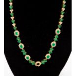 A diamond and emerald cluster 18ct yellow gold line necklace,