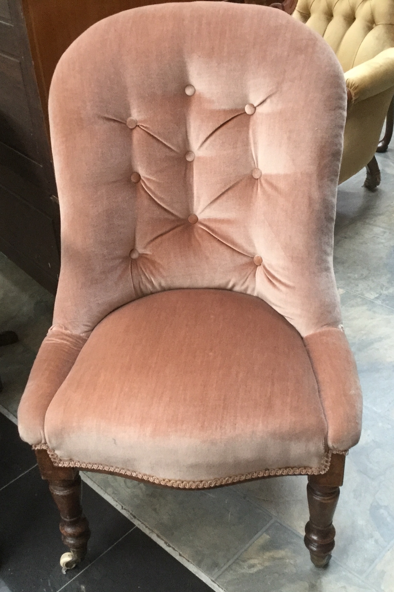 A mid Victorian mahogany dusky pink ladies upholstered chair, with deep buttoned back,