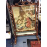 A mid Victorian walnut fire screen, having an inset woolwork panel depicting a religious study,