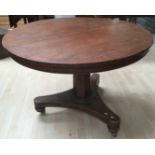 An early 19th Century mahogany round tilt top pedestal breakfast table..