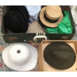 A suitcase of vintage hats, ladies and gents and also military issue 1955 pith helmet,