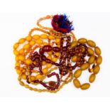 A collection of beads including a two tone amber strand,