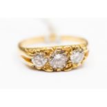 A diamond three stone 18ct gold boat head ring, the three round brilliant cut diamonds,