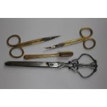 Two pairs of Asprey gilded dressing table scissors with engine turned decoration,