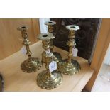 A set of four George III style brass candlesticks,